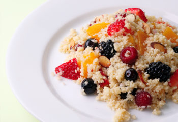 Couscous and fruit salad on a white plate
