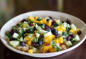 Quinoa blueberry mango salad in a white bowl
