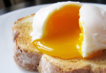 Poached egg on white toast on a plate