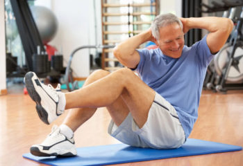 An older man doing exercises at the gym
