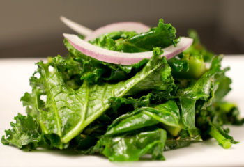 Cooked kale with red onion
