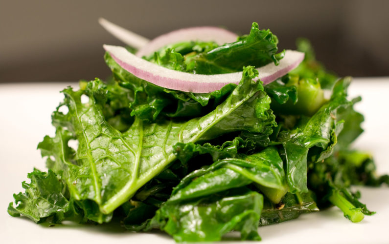 Cooked kale with red onion