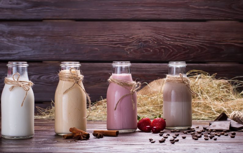 Different flavoured meal replacement shakes on the background of hay and sackcloth.